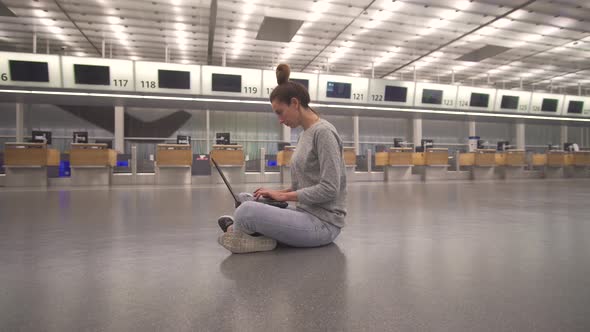 Woman Work on Laptop and Waiting for Flight in Airport