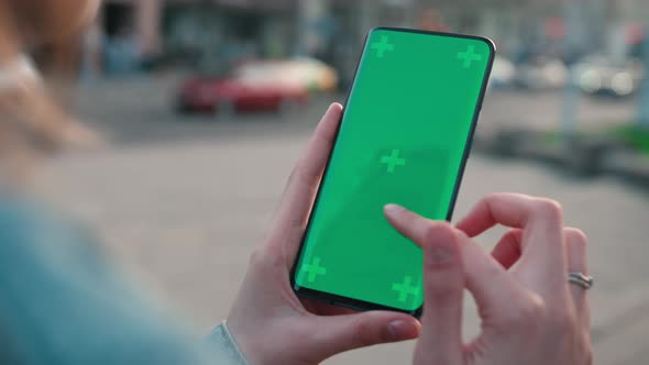 Lviv Ukraine May 6 2022 Close Up of a Woman's Hand Scrolling a Mobile Telephone with a Vertical