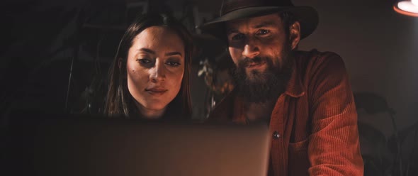 Man and Woman review work on laptop together