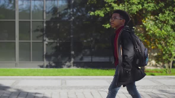 Side View of Cute African Preteen Boy with Backpack Going To School