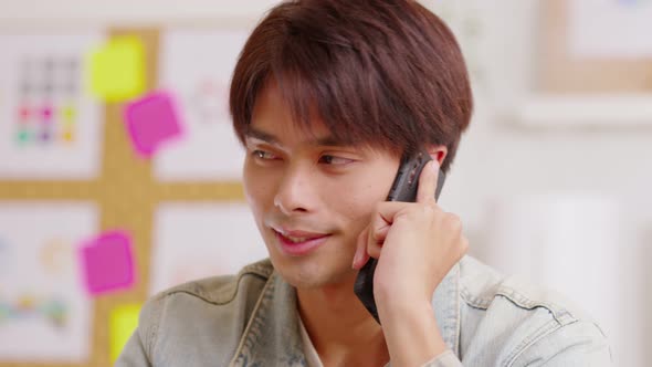 Closeup Asian smiling man talking mobile phone. Talking on smart phone with client and discussing ne