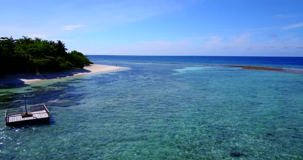 Luxury above tourism shot of a sandy white paradise beach and aqua blue water background 