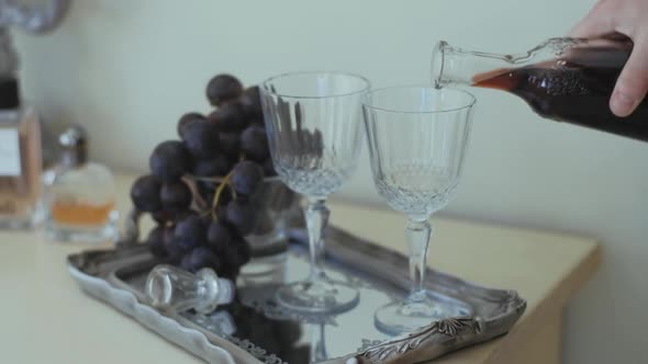 A carafe of red wine on the background of wedding rings. Wedding preparation