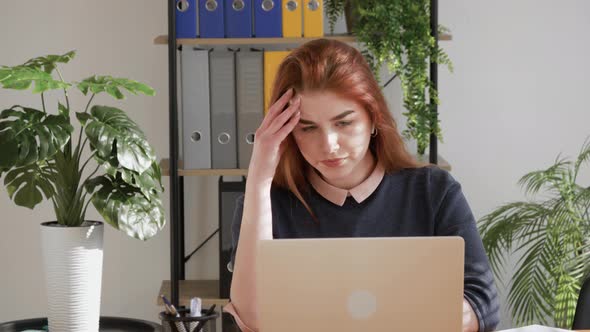 Shocked frustrated red hair female student feel stressed look at computer screen.