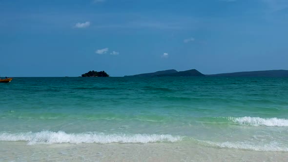 Low flying shot of white sand beach and blue sea on 4K beach, Koh Rong, Cambodia