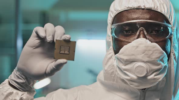 Portrait of African American Engineer Holding Microprocessor