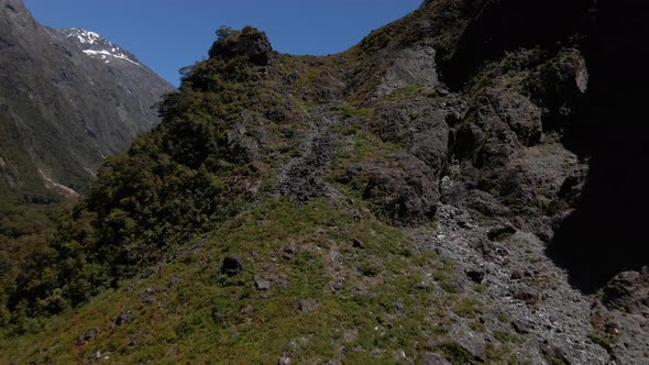 Steep rocky mountain slopes in a narrow valley in Fiordland Southland, New Zealand. Rocky mountain c