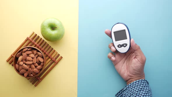 Diabetic Measurement Tools Almond Nut and Apple on Table