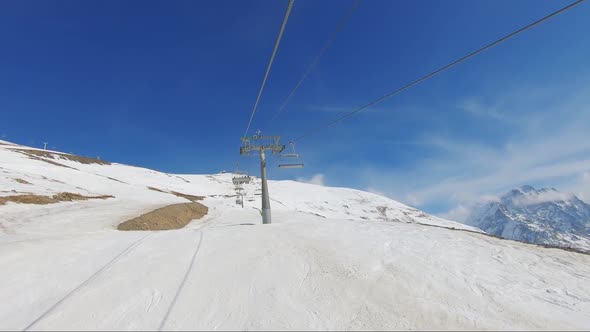 Winter Panorama with Ski Lifts and Snow Covered Mountains on a Sunny Day.