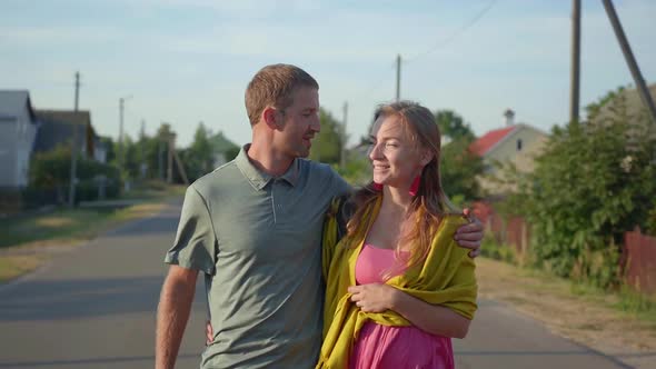 Young Couple in Love Go for a Walk in the Evening