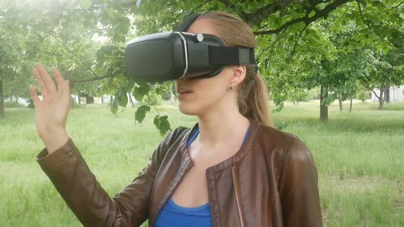 Woman Uses A Modern Virtual Reality Helmet In The Park