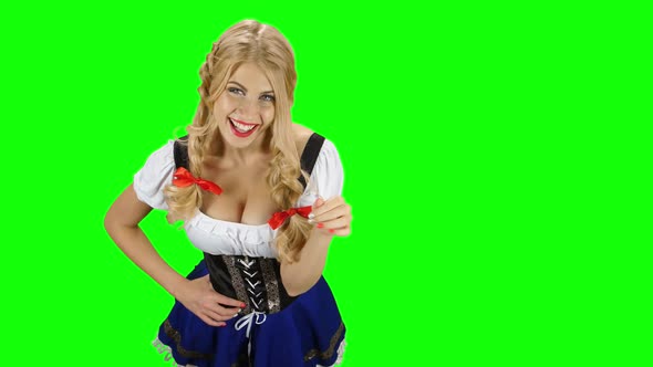 Woman in Traditional Costume Offers a Glass of Beer on Oktoberfest. Green Screen