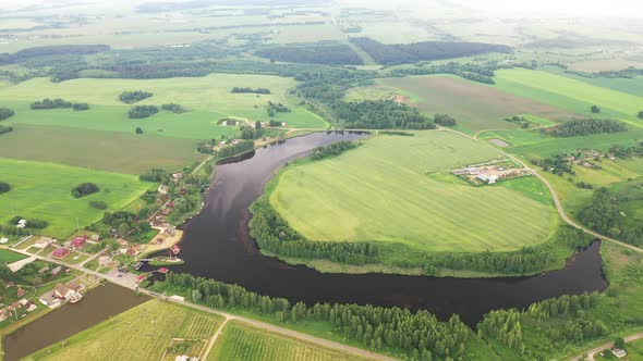 View From the Height of the Lake in a Green Field in the Form of a Horseshoe and a Village in the