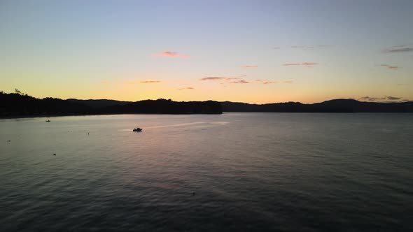 Cinematic aerial drone shot over moored boat in Cooks bay, New Zealand