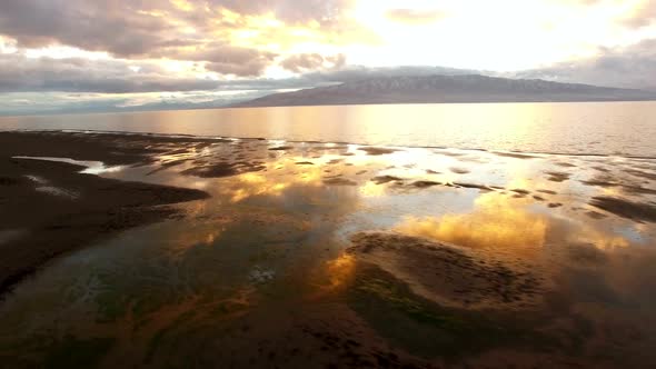 Panning aerial over water on shoreline