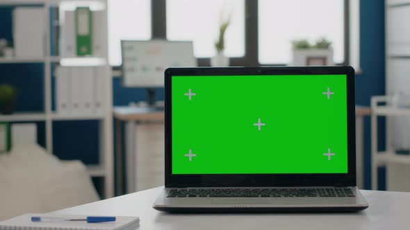 Close Up of Green Screen on Laptop at Empty Desk