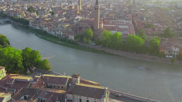 Aerial view of Verona City with bridges across Adige river. Medieval buildings with red tiled roofs