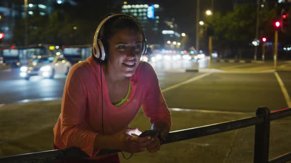 Young woman listening to music before running