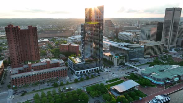 Skyscraper towers in Baltimore Maryland. Inner Harbor pullback aerial reveal.