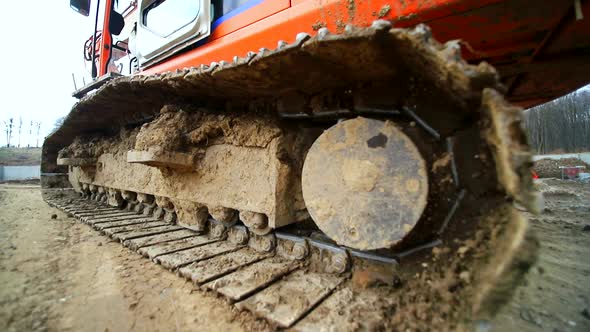 Close-up of a Caterpillar Crawler That Drives in a Swamp. Shot By Wide Angle Lens. Slow Motion