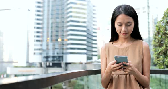 Woman use of mobile phone in the city