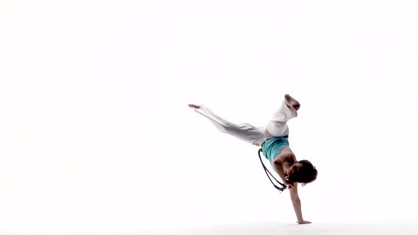 Energetic Girls Are Practicing Capoeira in White Background of Studio. Afro-Brazilian Martial Art