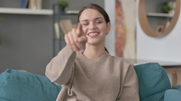 Portrait of Woman Pointing Towards Camera