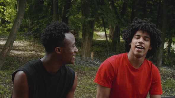 Two Happy African Male Friends Talking Spending Time Together Outdoors