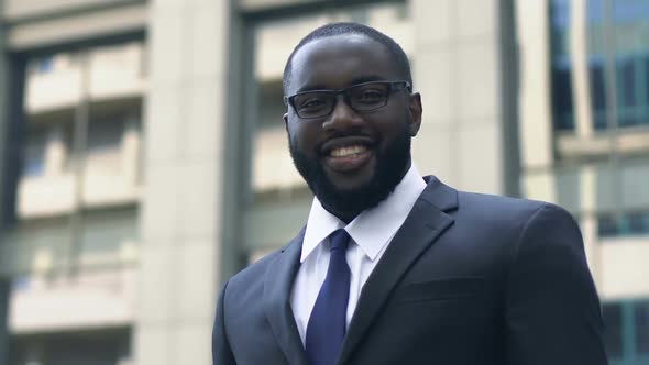 Successful Afro-American Businessman Looking at Camera Crossing Hands, Trade