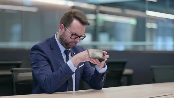 Middle Aged Businessman Checking Empty Wallet in Office