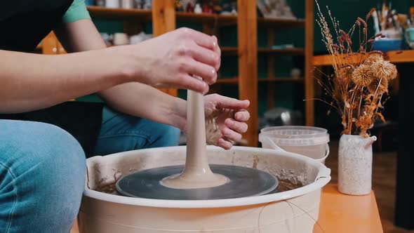 A Piece of Clay in Longer Shape Spinning on a Potter's Wheel