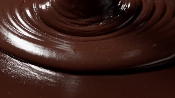 Pouring Melted Liquid Premium Dark or Milk Chocolate with Nuts Confectioner Prepares Dessert Icing