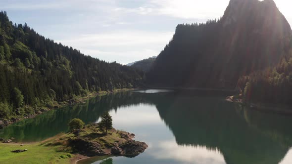 Peaceful lake surrounded by mountains in summer - jib up