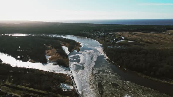 River Gauja with Melting Snow and Ice with Baltic Sea Gulf in Background in Spring Aerial