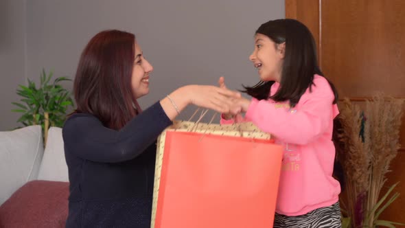 Little girl giving a gift to her mother.