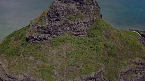 Aerial view of Chinaman's hat revealing the Kualoa mountains