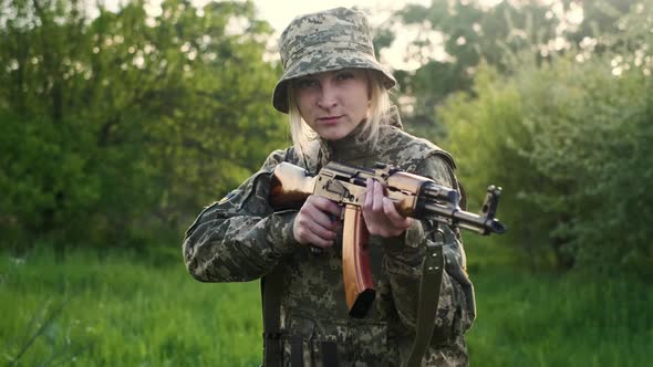 Ukrainian Female Soldier Armed with an Assault Rifle Patrols a Combat Zone