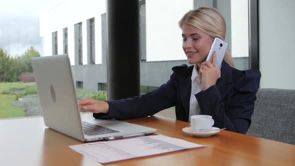 Woman Office Worker Holds Important Talks on the Phone