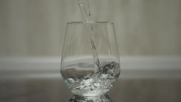 A Glass Being Filled Up with Water in Slow Motion 120Fps