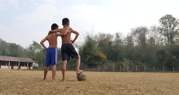 Rural Boys With Old Soccer Ball On The Football Field alt