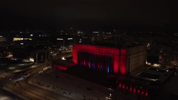 Aerial view of Helsinki Parliament House columns lighting up at night