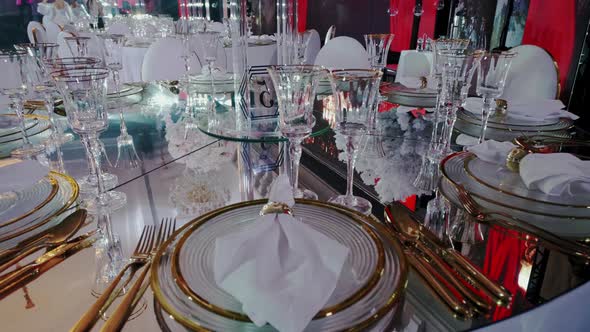 Close Up of Festive Wedding Table with Flowers in Red Lights