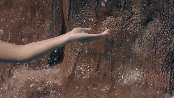 Lady with Long Nails Catches Water Drops with Left Palm