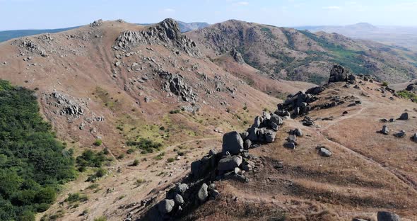 Aerial View Of Macin Mountain Range With Crag On Steep Slope On A Sunny Day In Dobrogea, Romania.