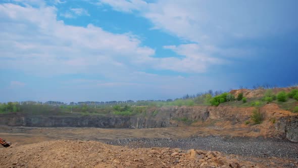 Construction site with heaps of sand and stones. Wasteland for building. Piles of soil surrounded by