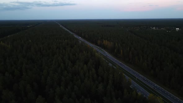 Aerial Establishing Shot: Camera Points Up at Passing Cars and Trucks on Highway