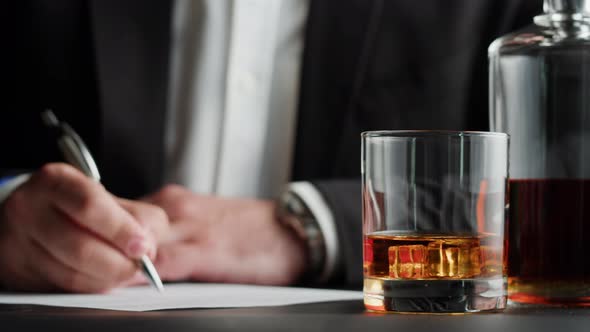 Businessman Drinking Brandy or Whiskey Closeup