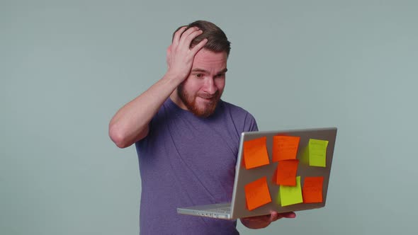 Exhausted Man Freelancer with Pasted Sticker Notes Using Laptop Computer Concentration Problem