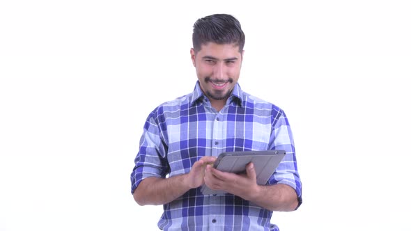 Happy Bearded Persian Hipster Man Thinking While Using Digital Tablet