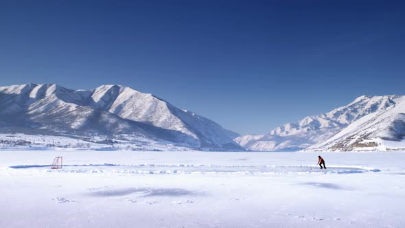 Hockey player on a frozen lake.